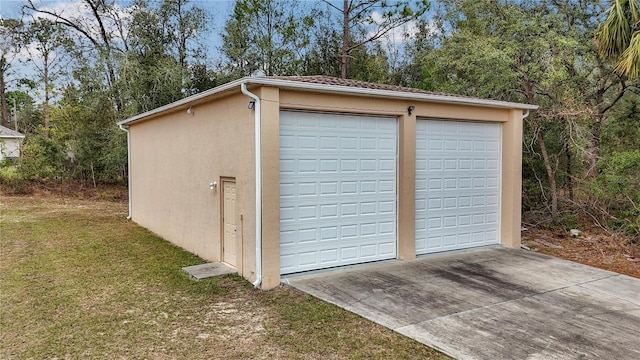 garage featuring a lawn