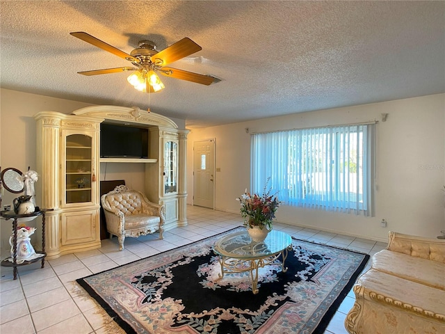 living room featuring a textured ceiling and light tile patterned floors