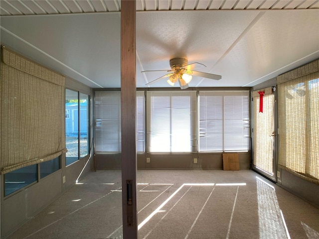 unfurnished sunroom featuring ceiling fan