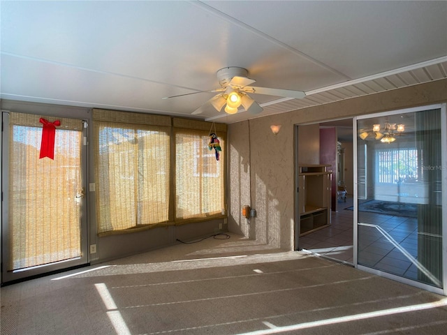 unfurnished sunroom with ceiling fan with notable chandelier