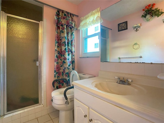 bathroom featuring vanity, tile patterned flooring, a shower with shower door, and toilet