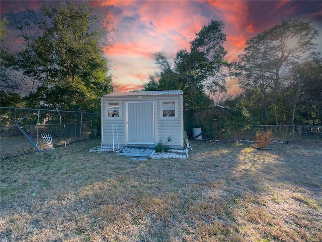 outdoor structure at dusk with a lawn