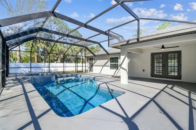 view of swimming pool with french doors, glass enclosure, a patio, and ceiling fan