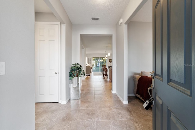 hallway featuring a textured ceiling