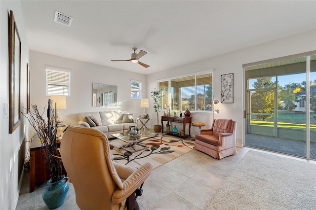 living room with light tile patterned floors and ceiling fan