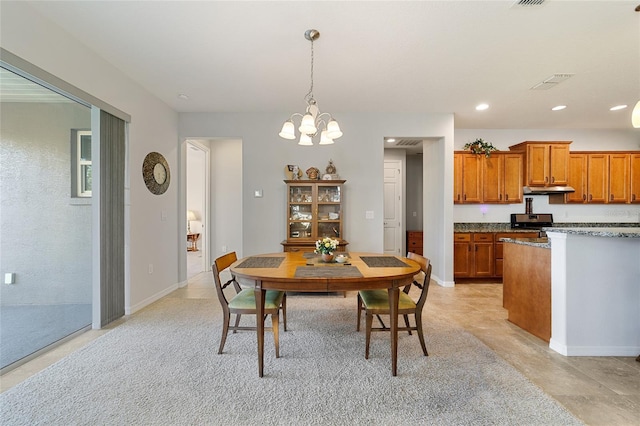 dining space with an inviting chandelier