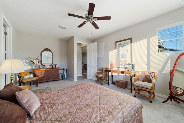 carpeted bedroom featuring ceiling fan and multiple windows