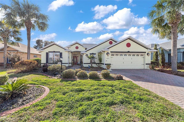 single story home featuring a garage and a front lawn