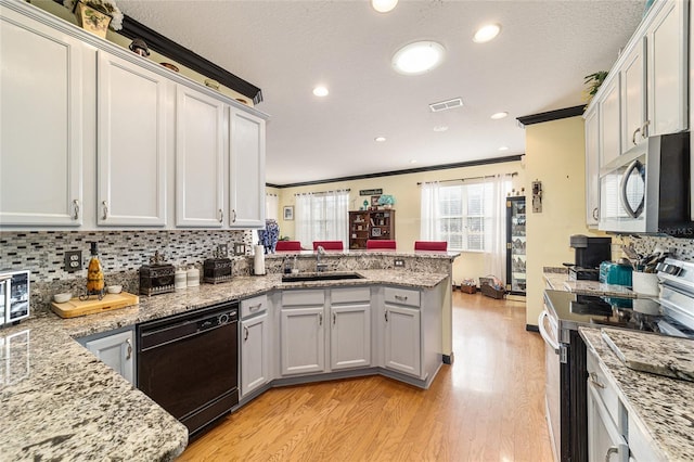 kitchen featuring sink, crown molding, stainless steel appliances, white cabinets, and kitchen peninsula