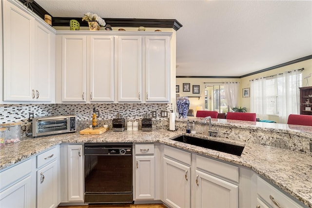 kitchen with dishwasher, sink, decorative backsplash, and white cabinets