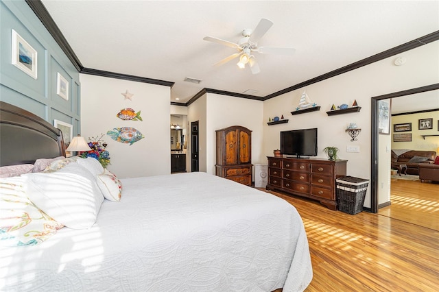 bedroom featuring connected bathroom, ornamental molding, light hardwood / wood-style floors, and ceiling fan