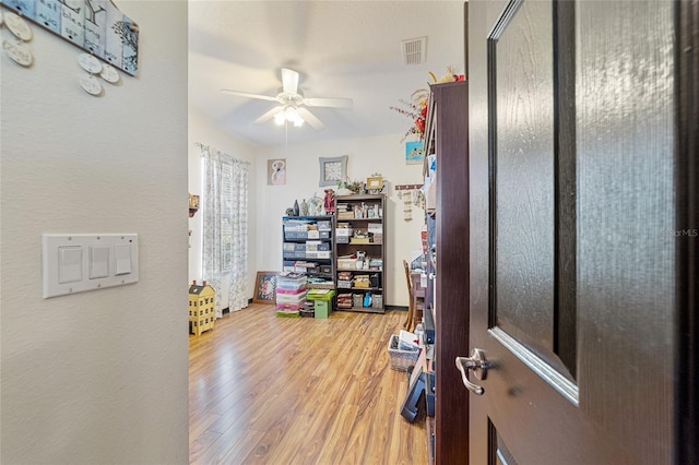 interior space with wood-type flooring and ceiling fan