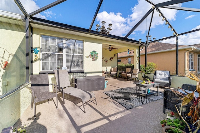 view of patio / terrace featuring outdoor lounge area, ceiling fan, and glass enclosure