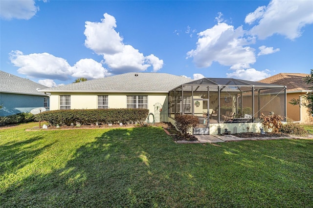 back of house with a yard and a lanai