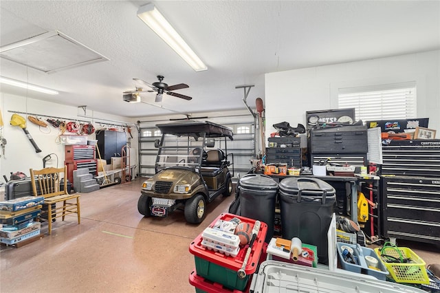 garage with a garage door opener and ceiling fan