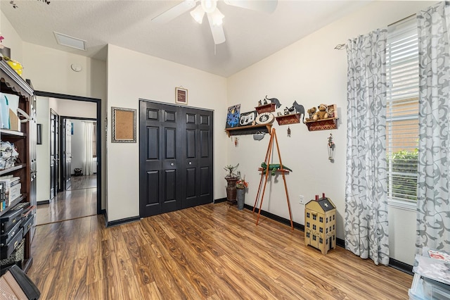 entrance foyer with ceiling fan, wood-type flooring, and a textured ceiling