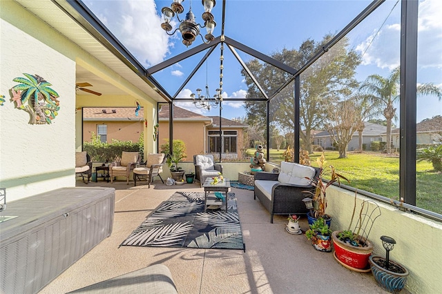 sunroom / solarium featuring a chandelier