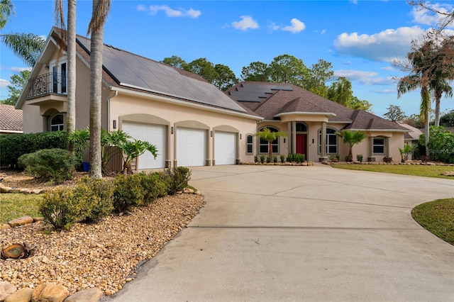 view of front of home featuring a garage and solar panels