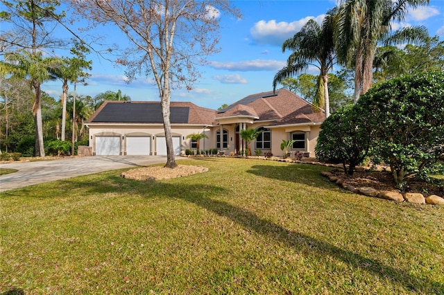 view of front of property with a garage and a front yard