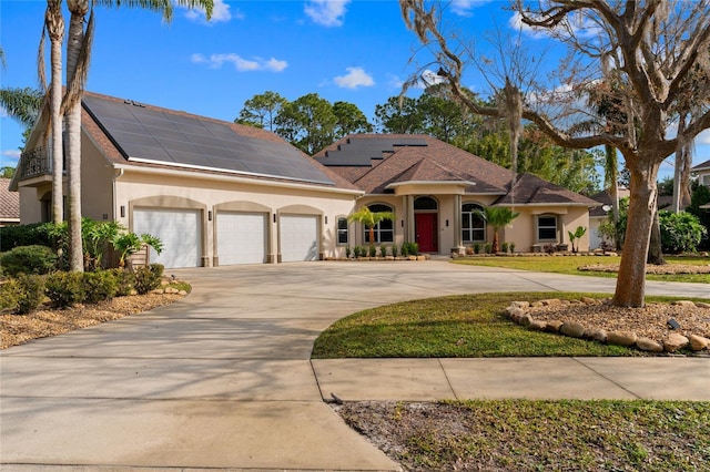 view of front of house featuring a garage and solar panels