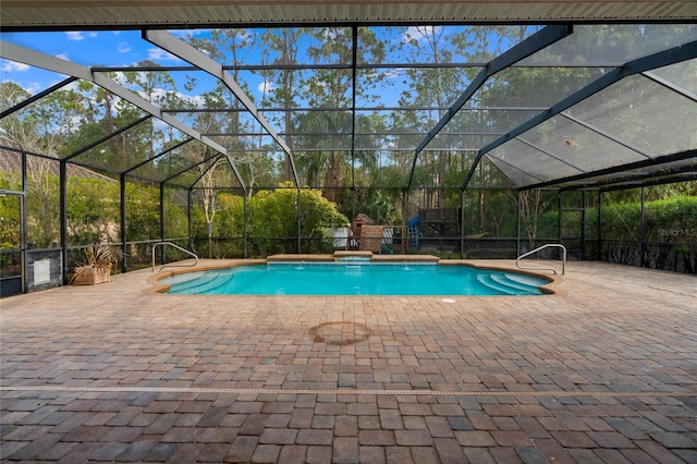 view of pool featuring pool water feature, glass enclosure, and a patio area