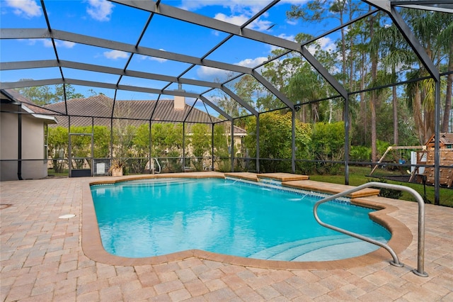 view of pool with a patio, a lanai, and pool water feature