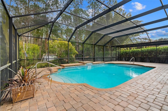 view of pool with pool water feature, a lanai, and a patio area