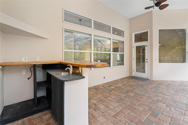 view of patio featuring ceiling fan and an outdoor wet bar