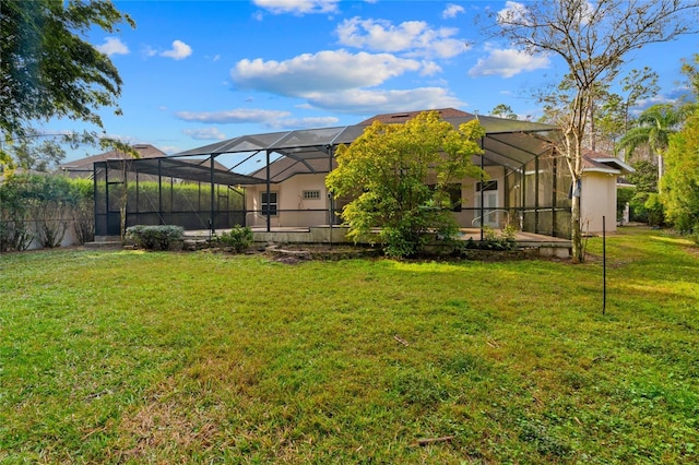 back of property with a lanai and a yard