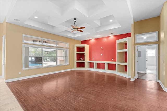 unfurnished living room featuring wood-type flooring, coffered ceiling, built in features, and ceiling fan