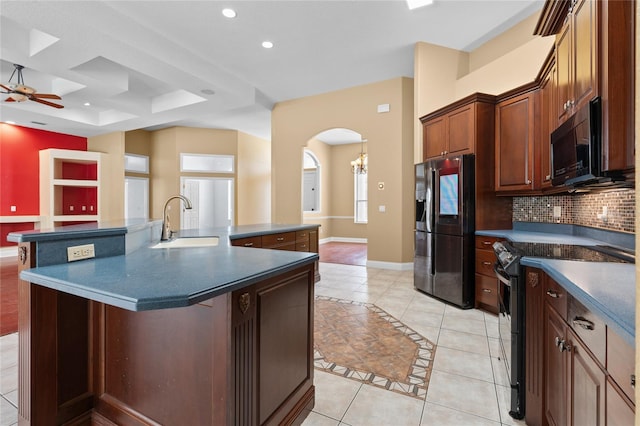 kitchen featuring sink, a large island, electric range, ceiling fan, and stainless steel fridge with ice dispenser