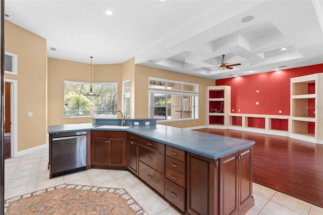 kitchen with sink, stainless steel dishwasher, pendant lighting, a healthy amount of sunlight, and a kitchen island with sink