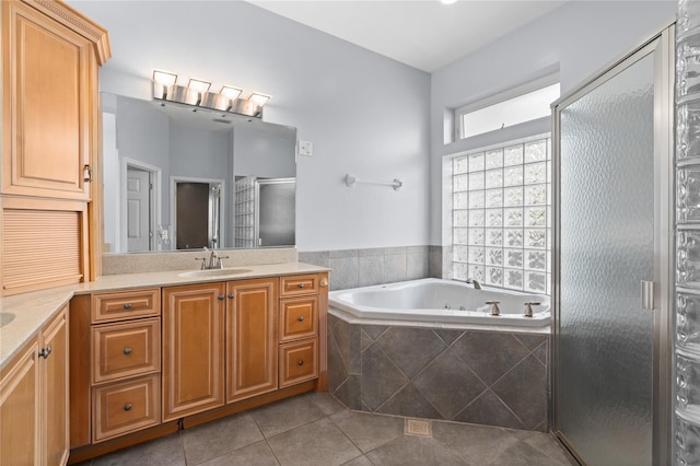 bathroom with tile patterned floors, shower with separate bathtub, and vanity