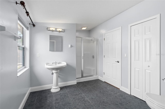 bathroom featuring walk in shower, toilet, and tile patterned flooring