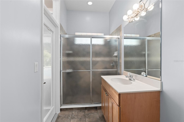 bathroom featuring vanity and a shower with door