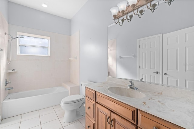 full bathroom featuring tile patterned floors, toilet, tiled shower / bath combo, and vanity