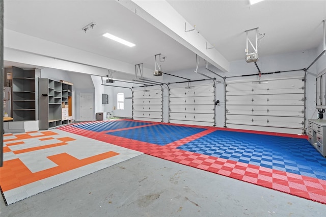 garage with a garage door opener and electric panel