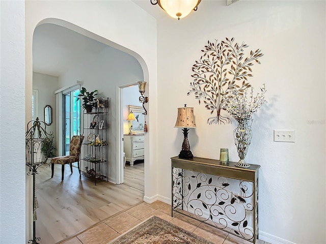 hall with light tile patterned floors