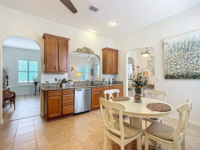 kitchen featuring ceiling fan, stainless steel dishwasher, light tile patterned flooring, and sink