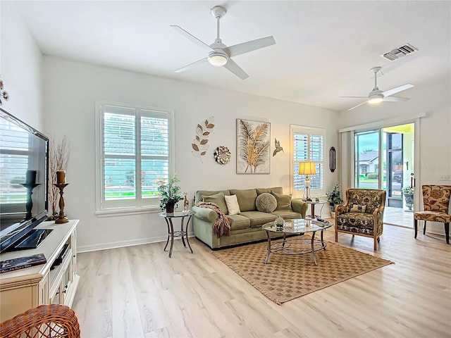 living room with ceiling fan and light hardwood / wood-style floors