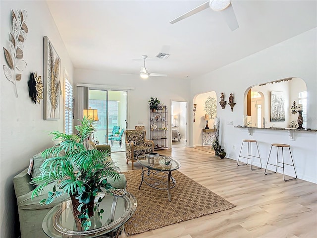 living room featuring ceiling fan and light hardwood / wood-style flooring