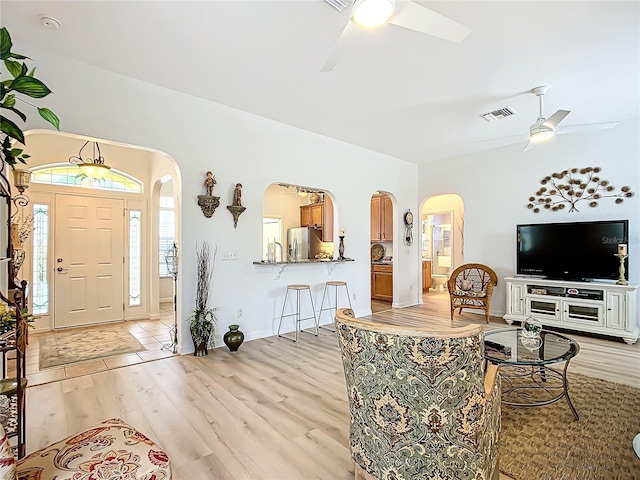 living room featuring ceiling fan and light wood-type flooring