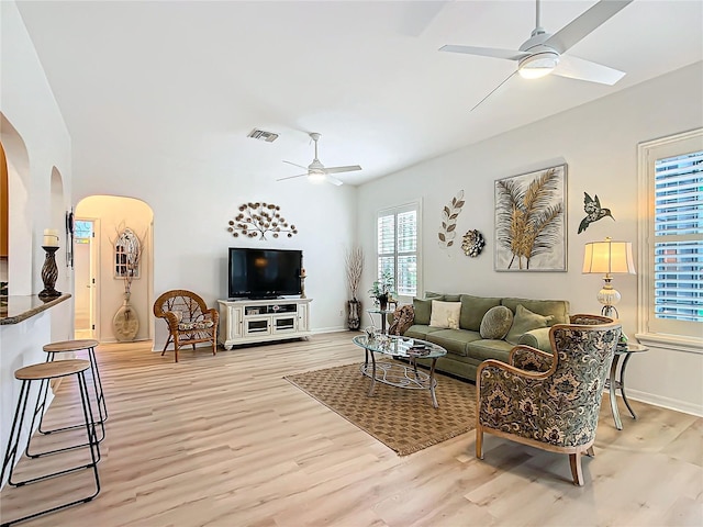 living room with ceiling fan and light wood-type flooring