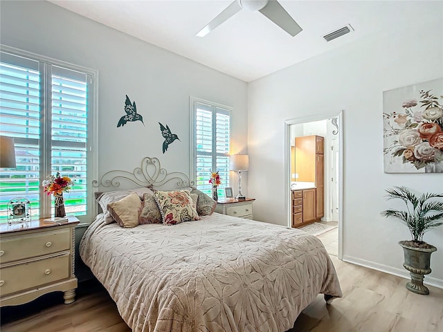 bedroom with ensuite bath, light hardwood / wood-style flooring, and ceiling fan