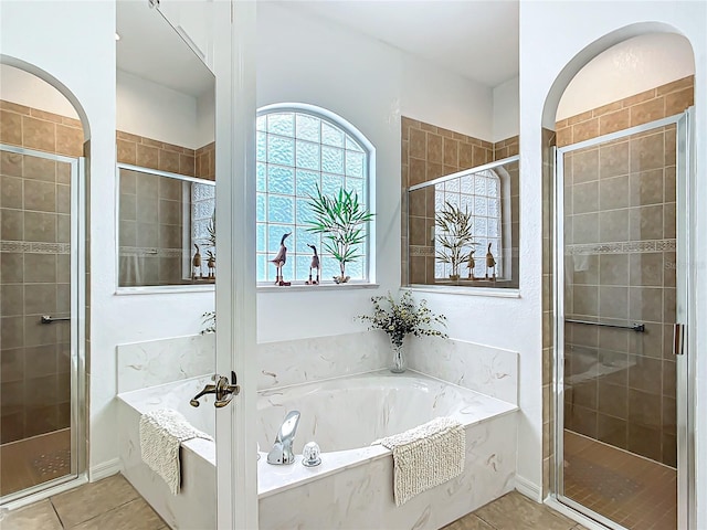 bathroom with tile patterned floors and independent shower and bath