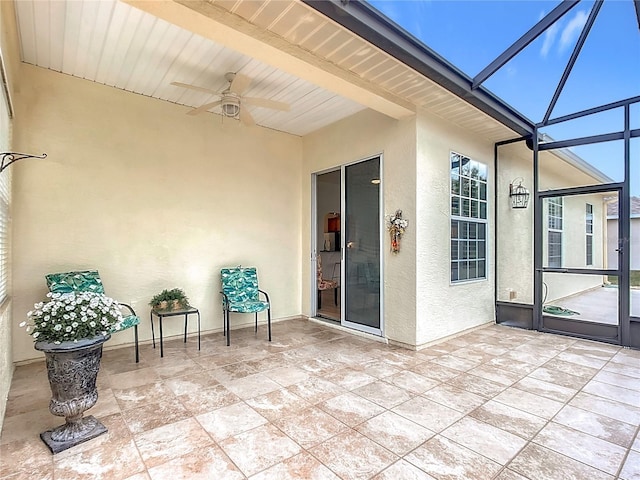 view of patio with a lanai and ceiling fan