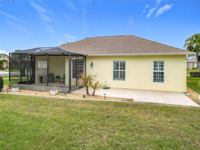 rear view of house with a lanai, a yard, and a patio area