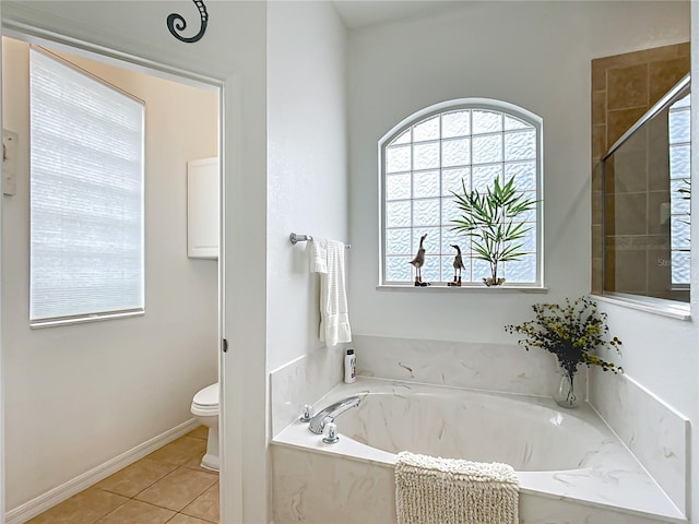 bathroom featuring plus walk in shower, tile patterned floors, and toilet