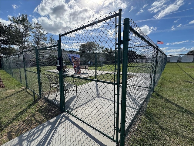 view of gate featuring a yard