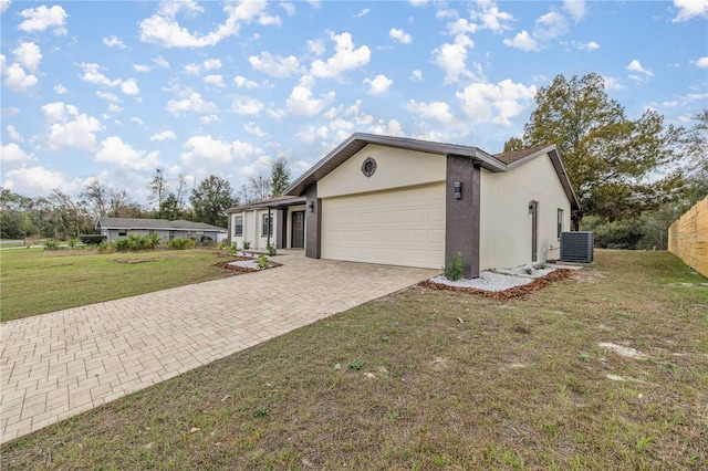 view of property exterior featuring cooling unit, a garage, and a yard